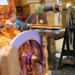 Spinning wool at a wheel
